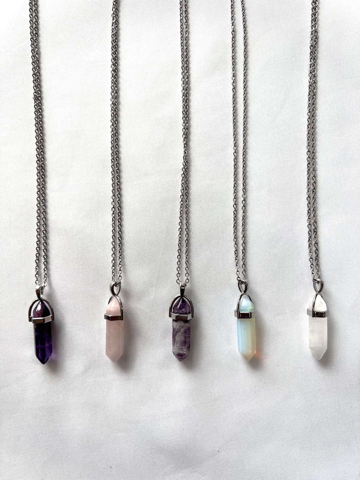 Pencil-shaped crystal on a silver chain. Choose between: amethyst, aventurine, rose quartz, fluorite, opalite, or clear quartz